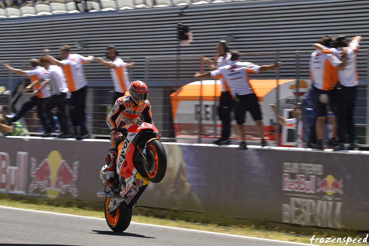 Marc Marquez wheelieing across the line